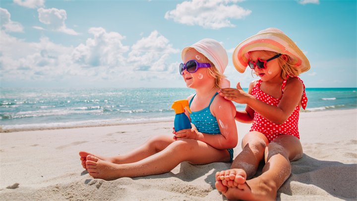 Girls with sun protection at beach vacation