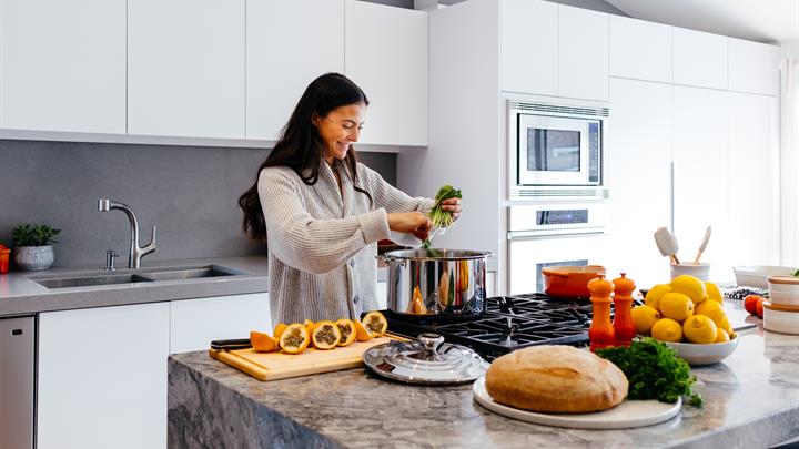 Woman smiling while cooking in the kitchen