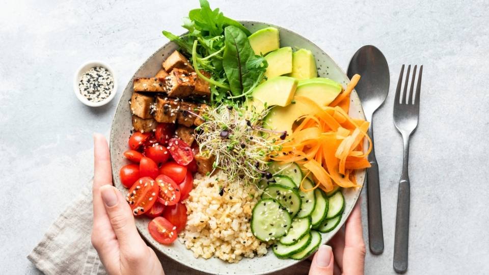 Buddha bowl salad in female hands