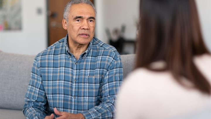 Man talking to health care professional in an office