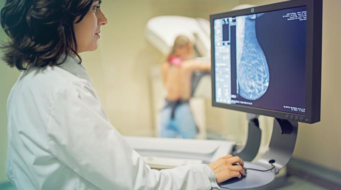 Health professional looking at mammogram image