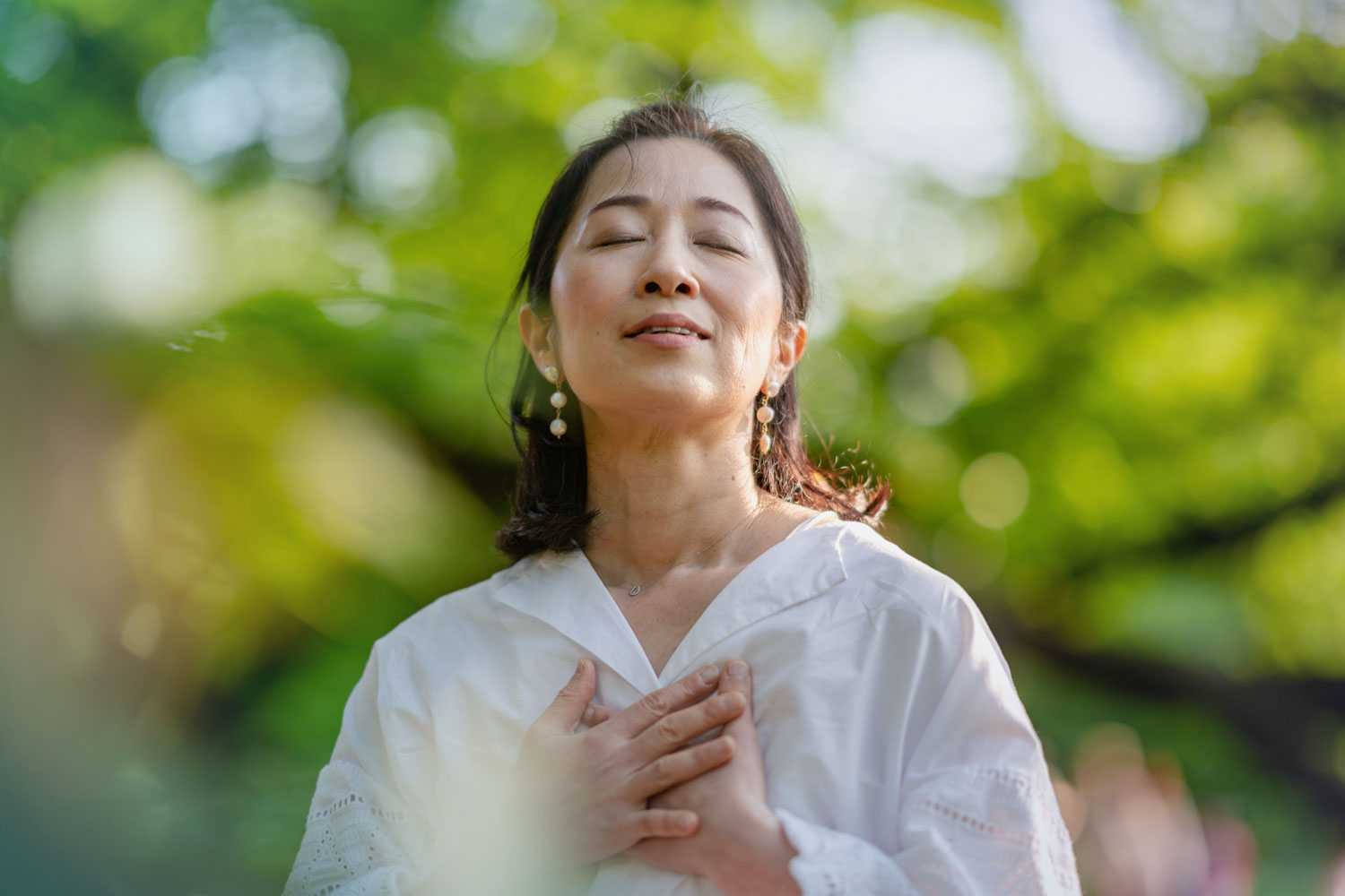 Woman breathing deeply outside in nature
