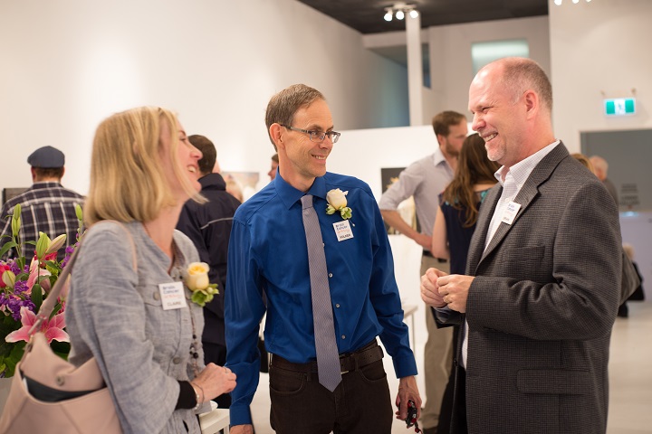 Smiling group chatting at art gallery