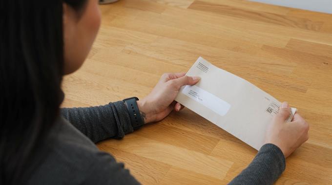 A person holding a letter from BC Cancer 