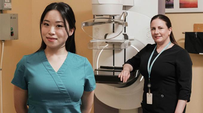 Two Technologists with a mammography machine