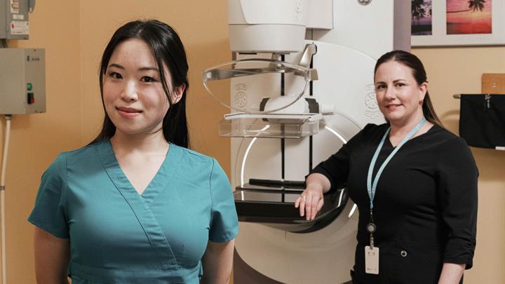 Two Technologists with a mammography machine